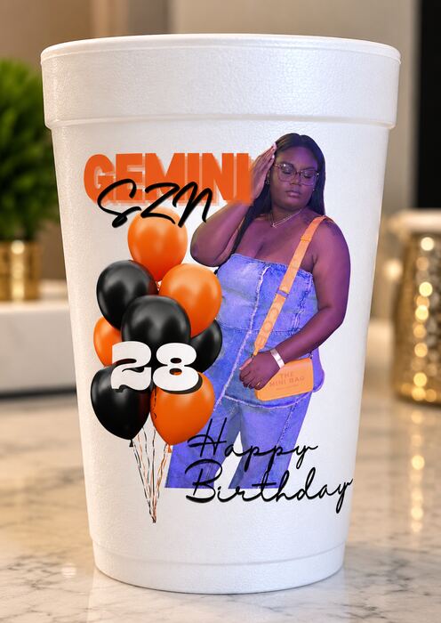 White party cup printed with a birthday photo, orange and black balloons and Happy Birthday script