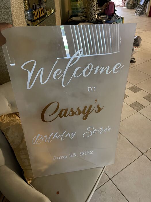 Frosted acrylic birthday welcome sign with white and gold lettering