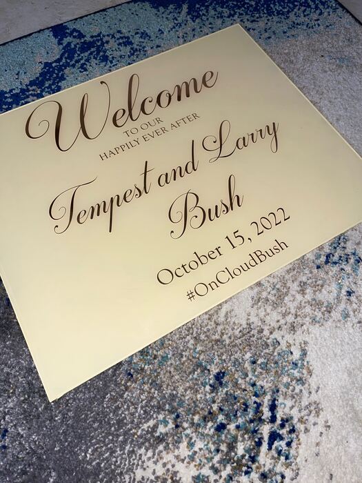 Cream acrylic wedding welcome sign with brown script lettering